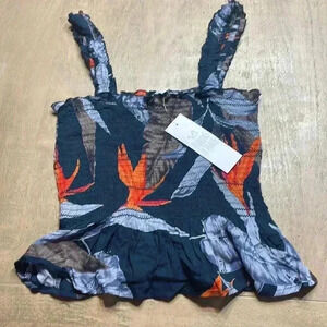 Patrons of Peace size Small, stretchy tank top with ruffled bottom.